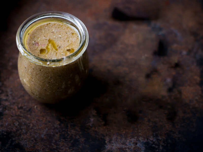 balsamic vinaigrette in jar on dark backdrop