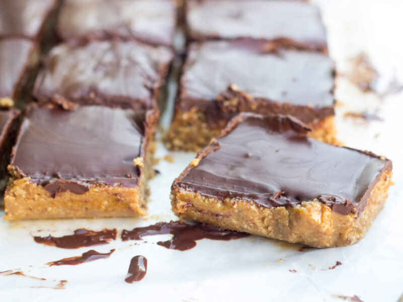 almond coconut bars topped with chocolate