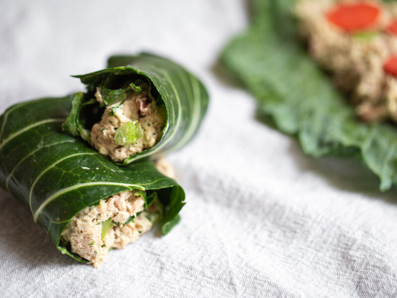 tuna salad in a collard wrap on a white background