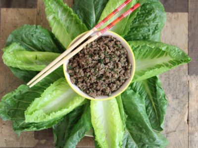 Thai Beef Lettuce wraps arranged decoratively like a flower with beef in the center and romaine leaves as the petals.
