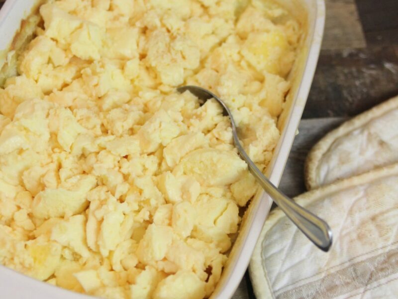 Wide shot of fluffy scrambled eggs in a 9 x 13 white casserole dish.