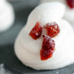 Horizontal image of a homemade marshmallow piped with eyes and mouth made with dried cranberries.