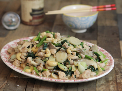 Cashew chick stir-fry on plate on wood backdrop