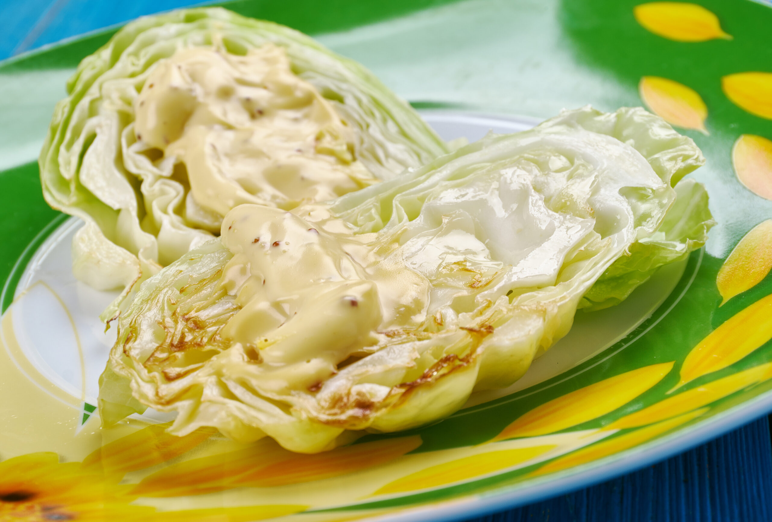 An image of roasted cabbage with sauce.