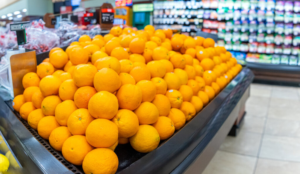 An image of oranges for sale in a grocery store.