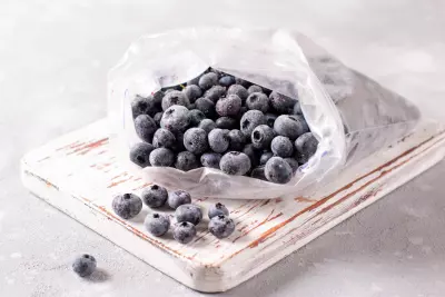 An image of frozen blueberries in a freezer bag.