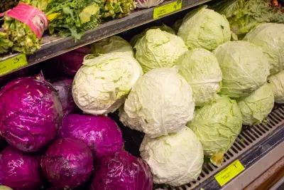 An image of cabbage on a grocery store shelf.