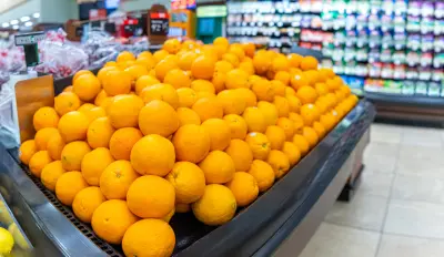 An image of oranges for sale in a grocery store.