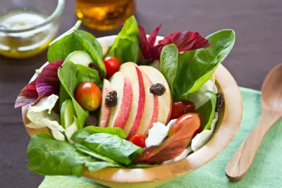 An image of a salad containing apple slices.